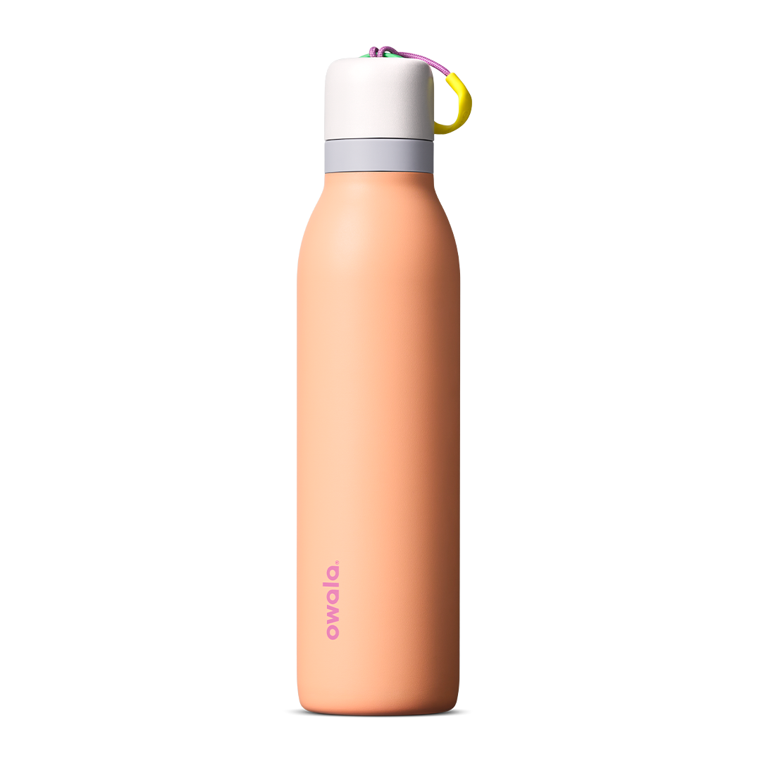 FreeSip Twist 24oz in Peachy Keen (soft coral-peach) with a light grey lid and multicolor loop accent, shown